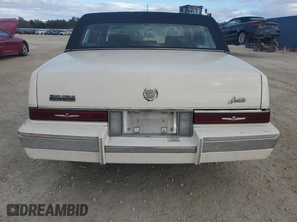 1987 Cadillac Seville z VIN 1G6KS518XHU812739, wystawiony jako Copart lot #79308574 z przebiegiem Nie podano mil oraz Szkoda całkowita • Salvage title. Historia ofert i sprzedaży dostępna na DreamBid. Obrazek 6.