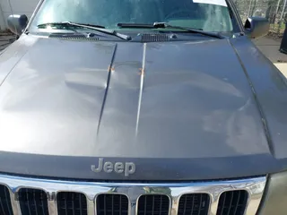 2003 Jeep Grand Cherokee Laredo with VIN 1J4GX48S53C504225, listed as a IAAI auction lot 41879669 with 247,246 mi miles. Bid and sale history available at carsss.com. Image 18.