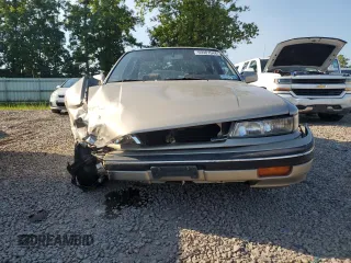 1989 Mitsubishi Galant with VIN JA3BR56V1KZ052149, listed as a Copart auction lot 69987544 with 74,232 mi miles and Salvage Title. Bid and sale history available at DreamBid. Image 5.