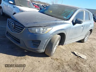 2016 Mazda CX-5 Sport with VIN JM3KE2BY3G0641895, listed as a IAAI auction lot 41689138 with 121,636 mi miles and . Bid and sale history available at DreamBid. Image 18.
