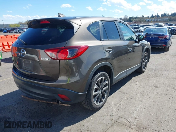 2016 Mazda CX-5 Grand Touring with VIN JM3KE2DYXG0773663, listed as a IAAI auction lot 41896367 with 86,571 mi miles and . Bid and sale history available at DreamBid. Image 4.