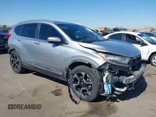 2018 Honda CR-V Touring z VIN 7FARW1H91JE036771, wystawiony jako IAAI lot #42514804 z przebiegiem 129 391 mil mil oraz . Historia ofert i sprzedaży dostępna na DreamBid. Obrazek 1.