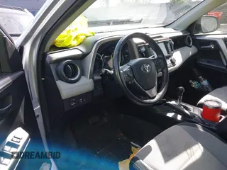 2016 Toyota RAV4 Hybrid XLE with VIN JTMRJREVXGD029019, listed as a IAAI auction lot 42021530 with 74,400 mi miles. Bid and sale history available at carsss.com. Image 6.