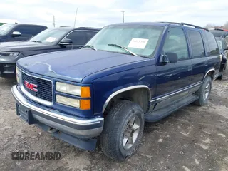 1997 GMC Yukon with VIN 1GKEK13R6VJ715421, listed as a IAAI auction lot 41811398 with 214,735 mi miles. Bid and sale history available at carsss.com. Image 2.