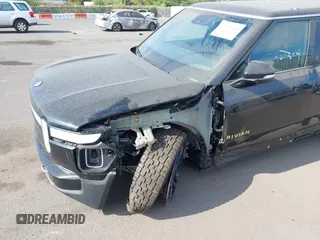 2023 Rivian R1S Adventure z VIN 7PDSGABA8PN020504, wystawiony jako IAAI lot #42025341 z przebiegiem 5989 mil mil oraz . Historia ofert i sprzedaży dostępna na DreamBid. Obrazek 6.