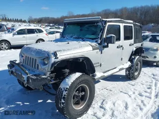 2010 Jeep Wrangler Unlimited Sport with VIN 1J4BA3H11AL102891, listed as a IAAI auction lot 41576869 with 213,204 mi miles. Bid and sale history available at carsss.com. Image 2.