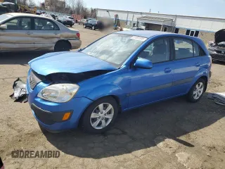 2009 Kia Rio LX with VIN KNADE243296500963, listed as a Copart auction lot 51061595 with 76,596 mi miles and Salvage Title. Bid and sale history available at carsss.com. Image 1.