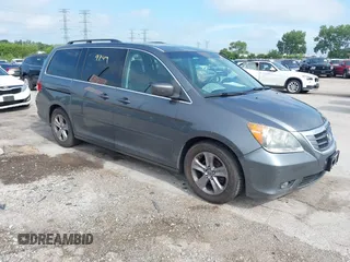 2010 Honda Odyssey Touring with VIN 5FNRL3H92AB061596, listed as a IAAI auction lot 42829749 with 127,632 mi miles and . Bid and sale history available at DreamBid. Image 1.