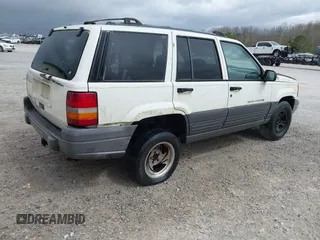 1996 Jeep Grand Cherokee Laredo with VIN 1J4FX58S1TC278511, listed as a IAAI auction lot 41837339 with 303,947 mi miles. Bid and sale history available at carsss.com. Image 4.