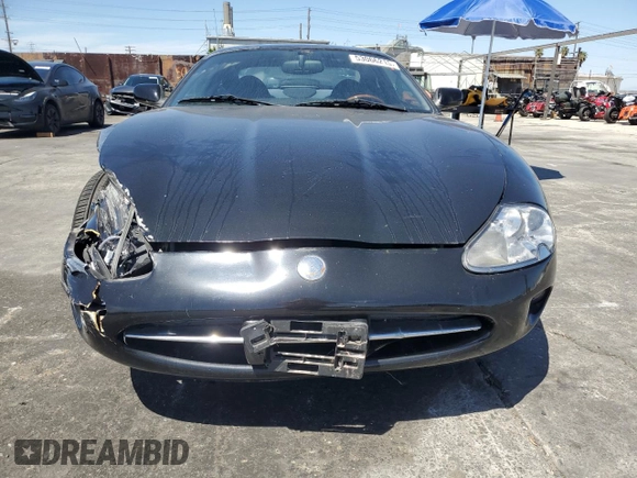 1997 Jaguar XK with VIN SAJGX5740VC014035, listed as a Copart auction lot 53066215 with 140,692 mi miles and Salvage Title. Bid and sale history available at DreamBid. Image 5.