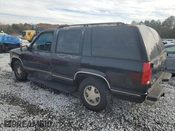 1999 GMC Yukon with VIN 1GKEC13R7XJ802387, listed as a Copart auction lot 82819934 with 438,574 mi miles and Salvage Title. Bid and sale history available at carsss.com. Image 2.
