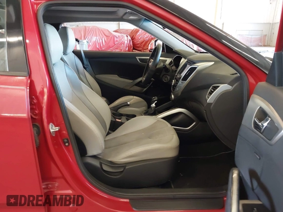 2012 Hyundai Veloster w/Gray Int z VIN KMHTC6AD3CU023998, wystawiony jako IAAI lot #42186875 z przebiegiem 170 771 mil mil oraz . Historia ofert i sprzedaży dostępna na DreamBid. Obrazek 5.