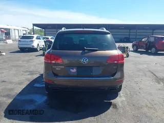 2014 Volkswagen Touareg Sport with VIN WVGEF9BP7ED003525, listed as a IAAI auction lot 41868307 with 74,379 mi miles and . Bid and sale history available at DreamBid. Image 16.