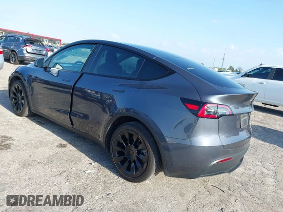 2023 Tesla Model Y Long Range z VIN 7SAYGDEE5PA099226, wystawiony jako IAAI lot #42004061 z przebiegiem 10 607 mil mil oraz . Historia ofert i sprzedaży dostępna na DreamBid. Obrazek 3.