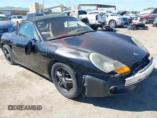 2000 Porsche Boxster z VIN WP0CA298XYU627713, wystawiony jako IAAI lot #41877815 z przebiegiem 100 427 mil mil oraz . Historia ofert i sprzedaży dostępna na DreamBid. Obrazek 1.