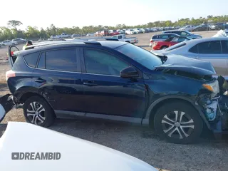 2018 Toyota RAV4 LE with VIN JTMZFREV1JJ203943, listed as a IAAI auction lot 41921863 with 104,691 mi miles. Bid and sale history available at carsss.com. Image 13.