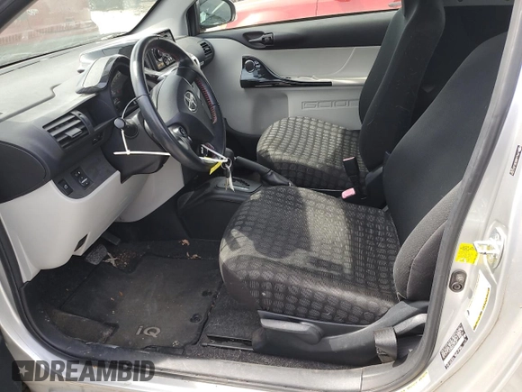 2012 Scion iQ with VIN JTNJJXB03CJ015321, listed as a Copart auction lot 54332355 with 63,439 mi miles and Salvage title. Bid and sale history available at DreamBid. Image 7.