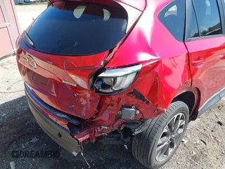 2016 Mazda CX-5 Grand Touring with VIN JM3KE2DY3G0686588, listed as a IAAI auction lot 41697312 with 65,090 mi miles. Bid and sale history available at carsss.com. Image 6.