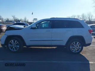2012 Jeep Grand Cherokee Laredo with VIN 1C4RJFAG5CC310893, listed as a IAAI auction lot 41695279 with 136,821 mi miles. Bid and sale history available at carsss.com. Image 14.