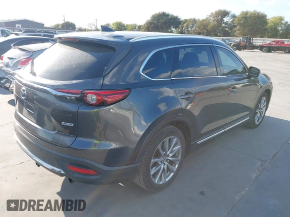 2016 Mazda CX-9 Grand Touring with VIN JM3TCADY8G0114940, listed as a IAAI auction lot 40701187 with 112,311 mi miles and . Bid and sale history available at DreamBid. Image 4.