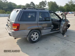 1999 Jeep Grand Cherokee Laredo with VIN 1J4G258S9XC731752, listed as a Copart auction lot 58601555 with 245,284 mi miles and Salvage title. Bid and sale history available at DreamBid. Image 3.