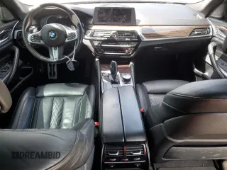 2018 BMW 5 Series M550i xDrive with VIN WBAJB9C57JB286734, listed as a Copart auction lot 52711235 with 127,450 mi miles and Salvage title. Bid and sale history available at DreamBid. Image 8.