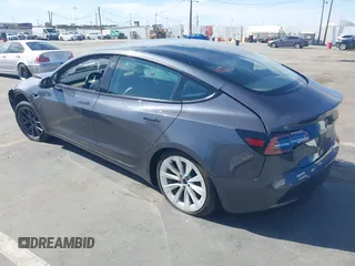 2022 Tesla Model 3 with VIN 5YJ3E1EA1NF142713, listed as a IAAI auction lot 42027630 with 112,557 mi miles. Bid and sale history available at carsss.com. Image 3.