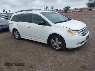 2013 Honda Odyssey Touring with VIN 5FNRL5H99DB041328, listed as a IAAI auction lot 41797520 with 148,523 mi miles and . Bid and sale history available at carsss.com. Image 1.