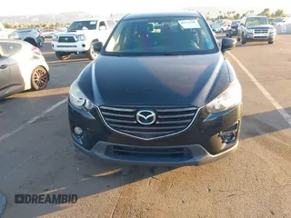 2016 Mazda CX-5 Touring with VIN JM3KE2CY5G0704574, listed as a IAAI auction lot 41033546 with 133,502 mi miles. Bid and sale history available at carsss.com. Image 12.