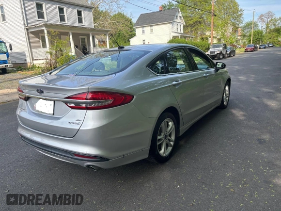 2018 Ford Fusion SE z VIN 3FA6P0LU9JR208728, wystawiony jako Copart lot #56345445 z przebiegiem 183 982 mil mil oraz Czysty tytuł • Clean title. Historia ofert i sprzedaży dostępna na DreamBid. Obrazek 4.