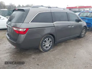 2012 Honda Odyssey EX-L with VIN 5FNRL5H6XCB057557, listed as a IAAI auction lot 42022410 with 174,286 mi miles and . Bid and sale history available at DreamBid. Image 4.