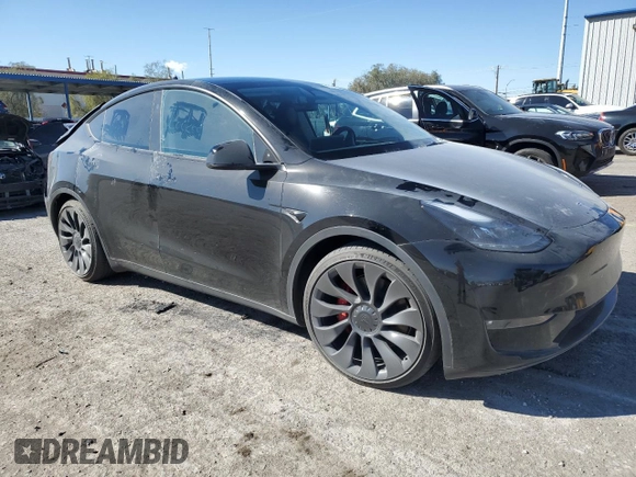 2023 Tesla Model Y Performance with VIN 7SAYGDEF7PF924355, listed as a Copart auction lot 47877055 with 64,663 mi miles and Salvage Title. Bid and sale history available at DreamBid. Image 4.