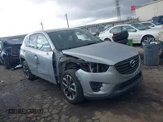 2016 Mazda CX-5 Grand Touring z VIN JM3KE2DY2G0673749, wystawiony jako IAAI lot #41731401 z przebiegiem 150 854 mil mil oraz . Historia ofert i sprzedaży dostępna na DreamBid. Obrazek 1.
