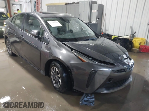 2021 Toyota Prius L Eco z VIN JTDKAMFU9M3132587, wystawiony jako IAAI lot #41637275 z przebiegiem 84 203 mil mil oraz . Historia ofert i sprzedaży dostępna na DreamBid. Obrazek 1.