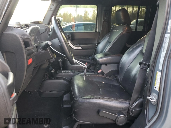 2015 Jeep Wrangler Unlimited Rubicon Hard Rock with VIN 1C4HJWFGXFL671660, listed as a Copart auction lot 82329074 with 214,579 mi miles and Salvage title. Bid and sale history available at DreamBid. Image 7.