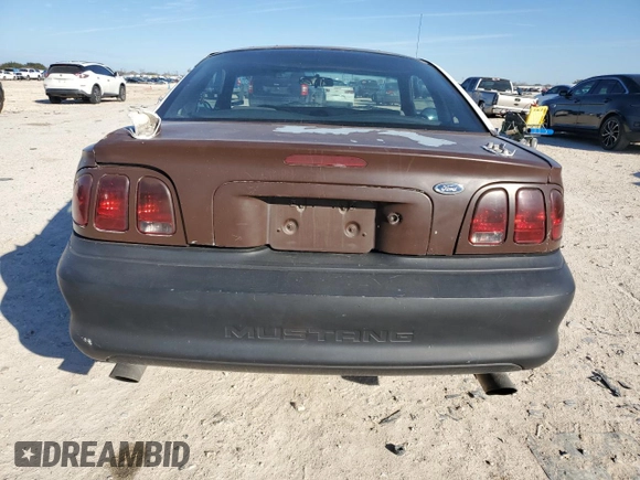 1997 Ford Mustang with VIN 1FALP4043VF174092, listed as a Copart auction lot 86983884 with 105,774 mi miles and Salvage Title. Bid and sale history available at carsss.com. Image 6.