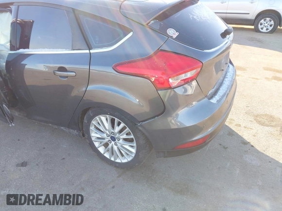 2015 Ford Focus Titanium z VIN 1FADP3N23FL368324, wystawiony jako IAAI lot #41387070 z przebiegiem Nie podano mil oraz . Historia ofert i sprzedaży dostępna na DreamBid. Obrazek 12.