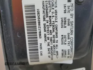 1999 Saturn SL z VIN 1G8ZH5280XZ178863, wystawiony jako Copart lot #73660474 z przebiegiem 195 738 mil mil oraz Szkody całkowita. Historia ofert i sprzedaży dostępna na DreamBid. Obrazek 13.