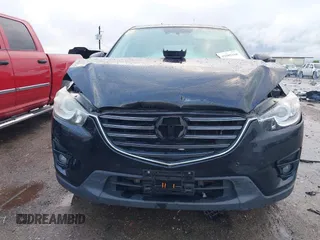 2016 Mazda CX-5 Grand Touring z VIN JM3KE4DY9G0605489, wystawiony jako IAAI lot #42085160 z przebiegiem 160 338 mil mil oraz . Historia ofert i sprzedaży dostępna na DreamBid. Obrazek 12.