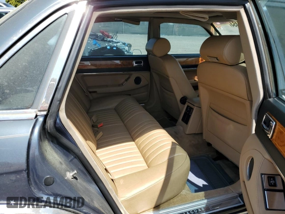 1992 Jaguar XJ with VIN SAJHY174XNC649368, listed as a Copart auction lot 50191454 with 99,553 mi miles and Salvage Title. Bid and sale history available at DreamBid. Image 10.