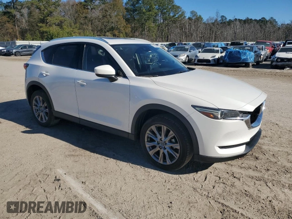2021 Mazda CX-5 Grand Touring with VIN JM3KFBDM0M1440565, listed as a Copart auction lot 87089404 with 34,607 mi miles and Salvage Title. Bid and sale history available at carsss.com. Image 4.