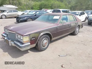 1985 Cadillac Seville z VIN 1G6KS6989FE821515, wystawiony jako IAAI lot #42009508 z przebiegiem 13 600 mil mil oraz . Historia ofert i sprzedaży dostępna na DreamBid. Obrazek 2.