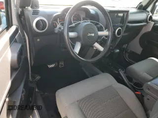 2009 Jeep Wrangler Sahara with VIN 1J4FA54149L708183, listed as a Copart auction lot 65989125 with 133,436 mi miles and Salvage title. Bid and sale history available at DreamBid. Image 8.