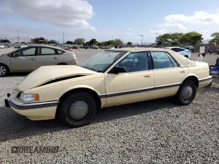 1992 Cadillac Seville z VIN 1G6KS53B0NU837105, wystawiony jako Copart lot #55865205 z przebiegiem 94 740 mil mil oraz Szkody całkowita. Historia ofert i sprzedaży dostępna na DreamBid. Obrazek 1.