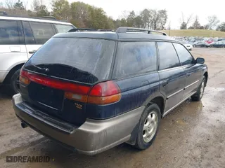 1997 Subaru Legacy Wagon Outback with VIN 4S3BG6854V7613017, listed as a IAAI auction lot 41574832 with 294,964 mi miles. Bid and sale history available at carsss.com. Image 4.