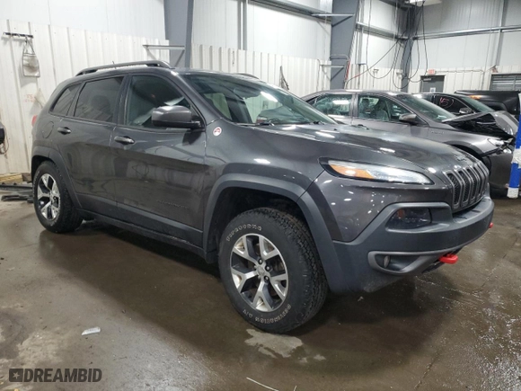 2015 Jeep Cherokee Trailhawk with VIN 1C4PJMBS6FW786085, listed as a Copart auction lot 48791955 with 123,574 mi miles and Salvage Title. Bid and sale history available at carsss.com. Image 4.