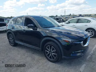 2018 Mazda CX-5 Grand Touring with VIN JM3KFBDM2J0390611, listed as a IAAI auction lot 42006482 with 97,497 mi miles. Bid and sale history available at carsss.com. Image 1.
