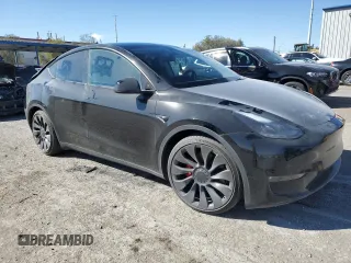 2023 Tesla Model Y Performance with VIN 7SAYGDEF7PF924355, listed as a Copart auction lot 47877055 with 64,663 mi miles and Salvage Title. Bid and sale history available at DreamBid. Image 4.