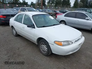 1999 Ford Escort SE z VIN 1FAFP13P5XW266521, wystawiony jako IAAI lot #41922487 z przebiegiem 129 366 mil mil oraz . Historia ofert i sprzedaży dostępna na DreamBid. Obrazek 1.