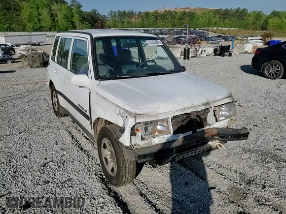 1997 Geo Tracker LSi z VIN 2CNBE1360V6927915, wystawiony jako Copart lot #53469605 z przebiegiem 119 413 mil mil oraz Szkoda całkowita • Salvage title. Historia ofert i sprzedaży dostępna na DreamBid. Obrazek 11.